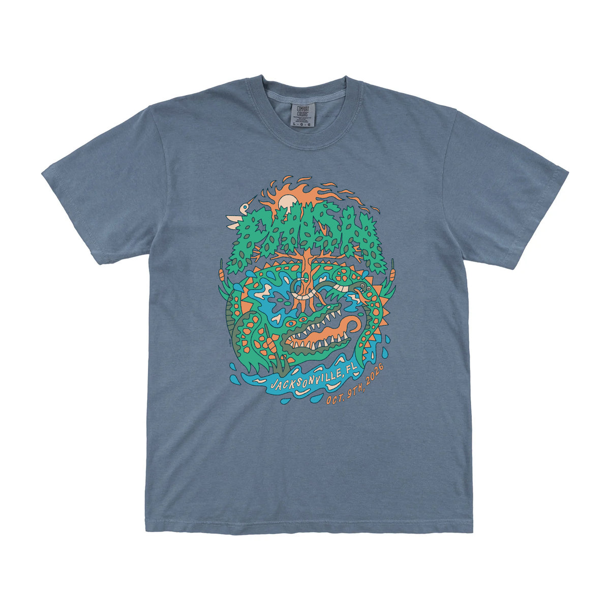 A slate blue crewneck t-shirt featuring a colorful graphic print of a stylized alligator surrounding trees and water, with the text 'Phish' and 'Jacksonville, FL, Oct. 9th, 2026' on a white background.
